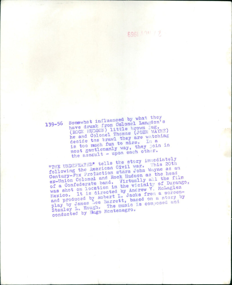 Ex-Union Colonel John Wayne and Confederate leader Rock Hudson brawl in a scene from the movie "The Undefeated." - Vintage Photograph