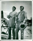 Ex-Union Colonel John Wayne and Confederate leader Rock Hudson brawl in a scene from the movie "The Undefeated." - Vintage Photograph