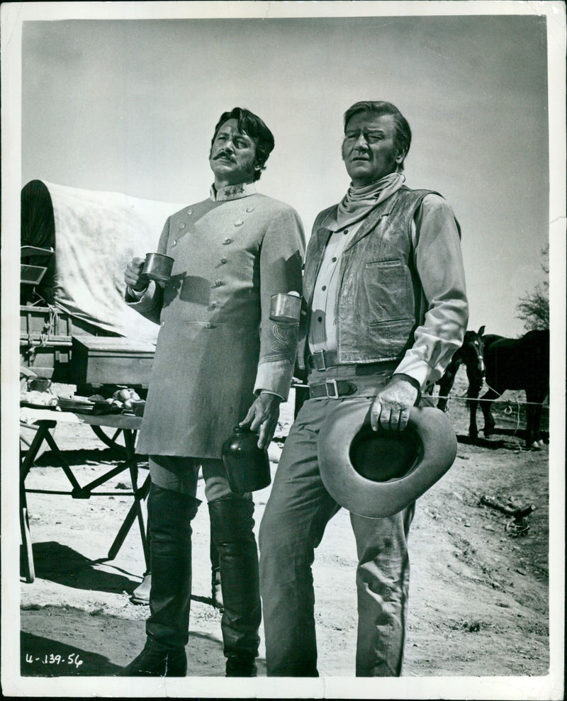 Ex-Union Colonel John Wayne and Confederate leader Rock Hudson brawl in a scene from the movie "The Undefeated." - Vintage Photograph