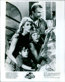 Sam Neill, Laura Dern, Arianna Richards, and Joseph Mazzello are seen in a scene from the 1993 Universal and Amblin film "Jurassic Park". - Vintage Photograph
