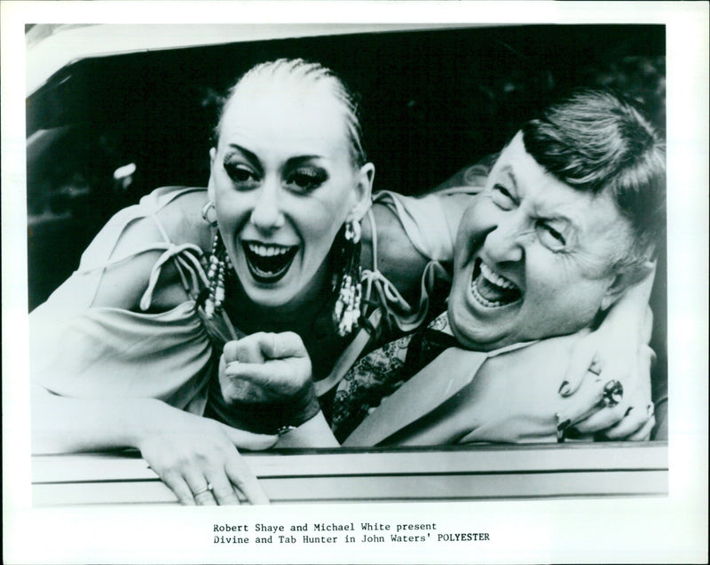 Robert Shaye, Michael White and Divine present John Waters' film Polyester, starring Divine and Tab Hunter. - Vintage Photograph