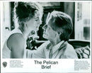 Julia Roberts and Sam Shepard share a tender moment in the Warner Bros. film "The Pelican Brief." - Vintage Photograph