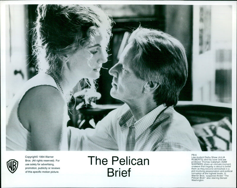 Julia Roberts and Sam Shepard share a tender moment in the Warner Bros. film "The Pelican Brief." - Vintage Photograph