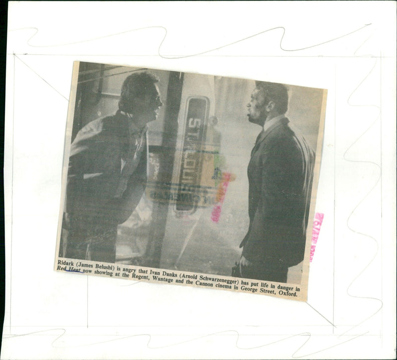 James Belushi is angered over the fact that Arnold Schwarzenegger has put his life in danger in the wild bus chase in the movie Red Heat. - Vintage Photograph