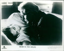 Mimi Rogers and Gary Busey in a scene from the 1989 thriller "Hider in the House". - Vintage Photograph