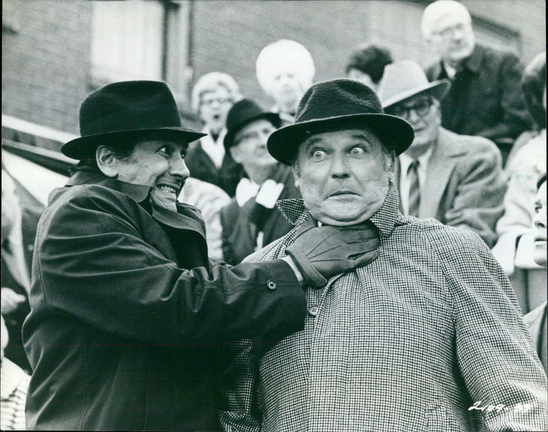 John Belushi and other cast members of "National Lampoon's Animal House" pose in costume on the set of the movie. - Vintage Photograph