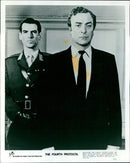 Michael Caine and Pierce Brosnan in a scene from the film "The Fourth Protocol." - Vintage Photograph