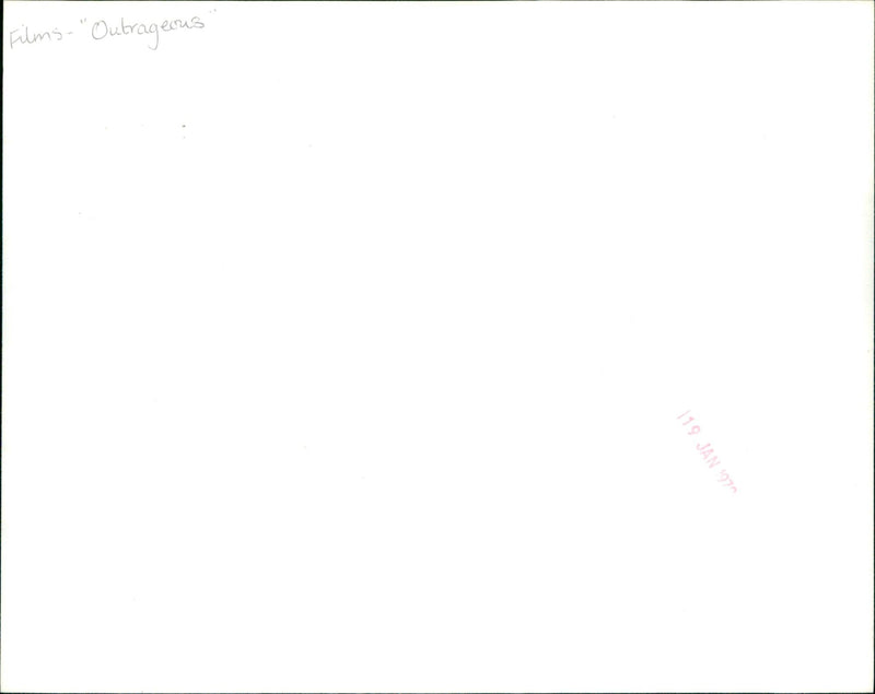 A moviegoer attends a midnight screening of the film "Outrageous 119" on January 1970. - Vintage Photograph