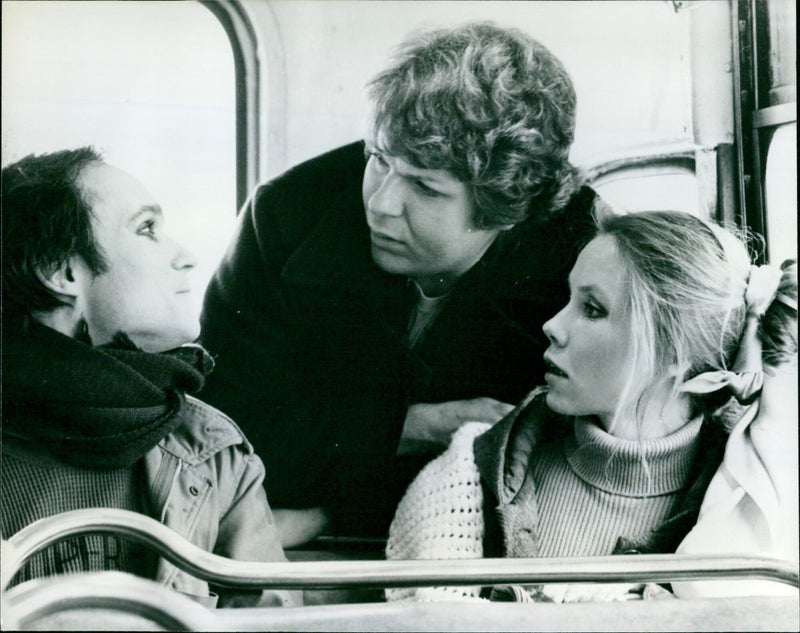 A moviegoer attends a midnight screening of the film "Outrageous 119" on January 1970. - Vintage Photograph