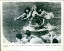 School of piranhas attack unsuspecting bathers in the film "PIRANHA". - Vintage Photograph