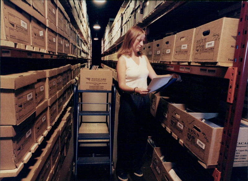 Archive operator Nicola Wells retrieves files from the bomb-proof shelter at the Datacare Business Systems Records Management Centre in Upper Heyford, Oxfordshire. - Vintage Photograph