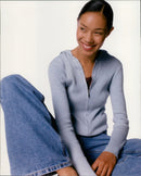 Model Pash Jeaus wearing a GAP Fall 1998 ribbed hooded sweater, knit camisole, and women's super wide jeans. - Vintage Photograph