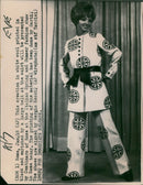 A model showcases a creation in white wool printed in black and enriched by a large belt at the waist at the Italian Spring and Summer fashion show in Rome. - Vintage Photograph