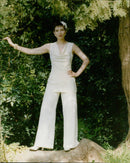 Model wearing stylish trousers walking on a catwalk. - Vintage Photograph