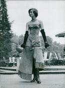 A mannequin models an azalea-coloured velvet-calfskin dress at a leather fashion show in Paris. - Vintage Photograph