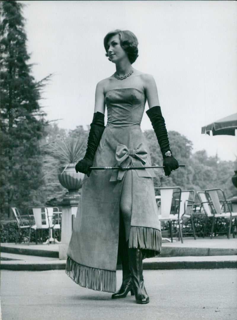 A mannequin models an azalea-coloured velvet-calfskin dress at a leather fashion show in Paris. - Vintage Photograph