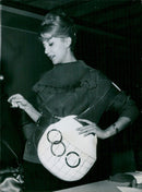 A unique handbag inspired by the 1960 Rome Olympics is modeled in London. - Vintage Photograph