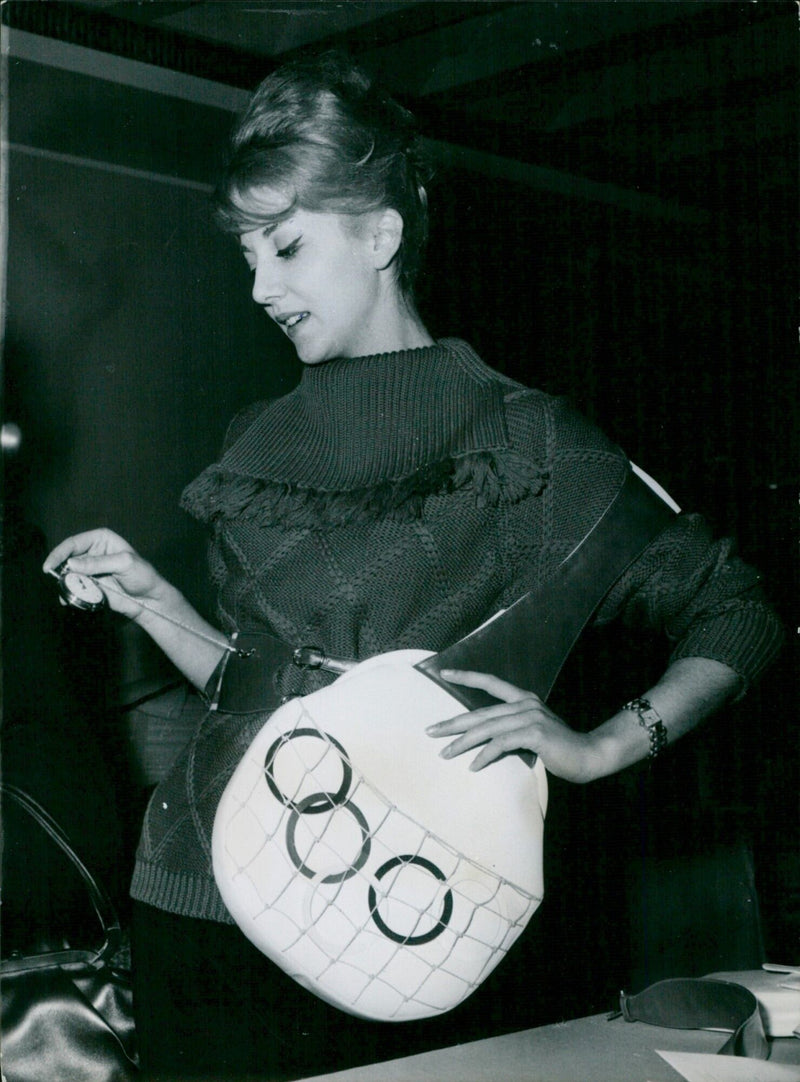 A unique handbag inspired by the 1960 Rome Olympics is modeled in London. - Vintage Photograph
