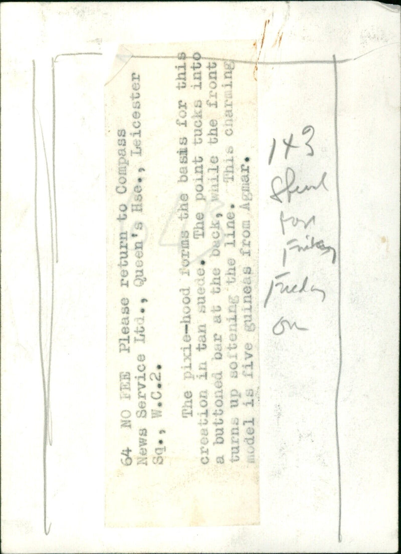 A model wearing a pixie-hooded tan suede creation from Agmar. - Vintage Photograph