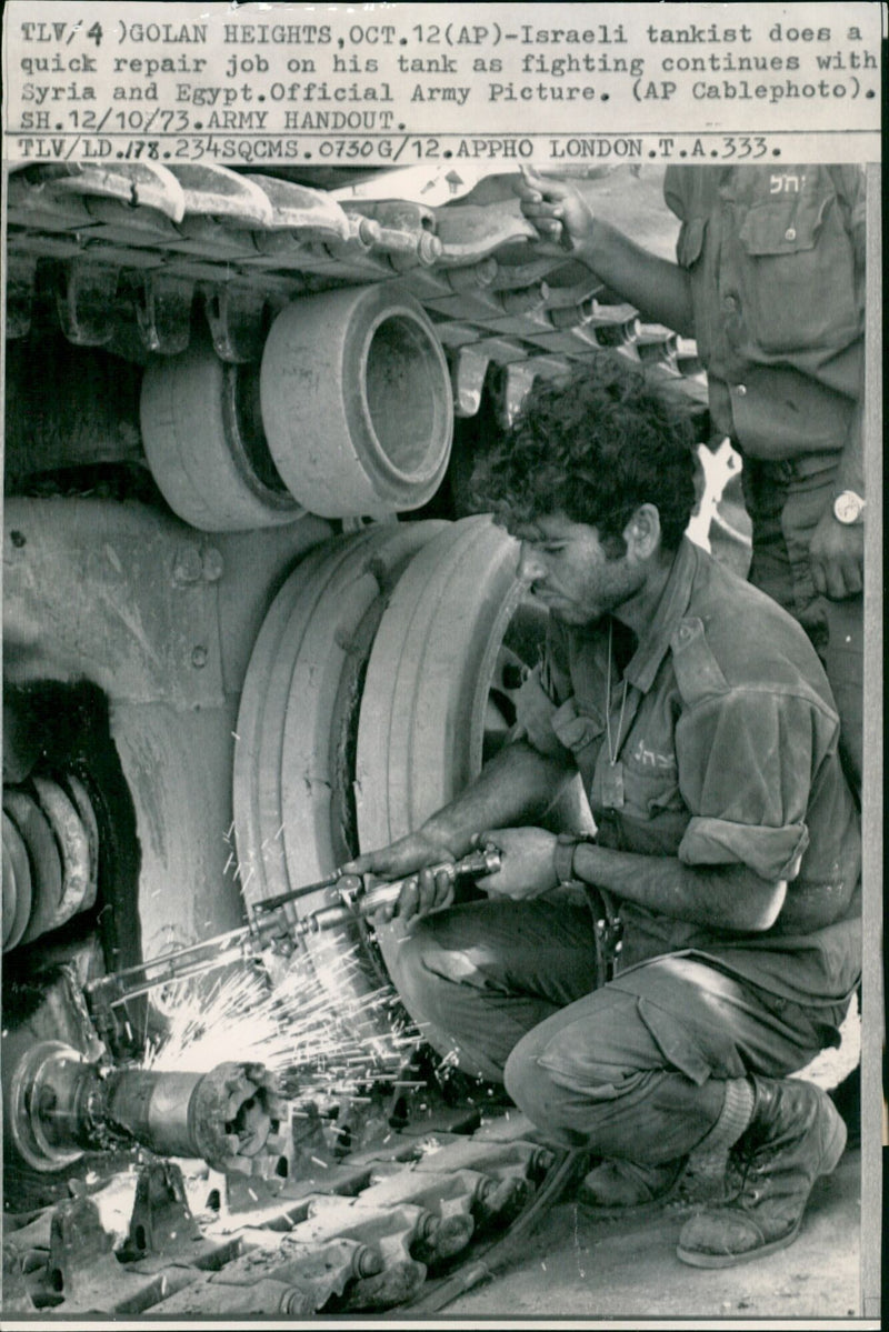 An Israeli soldier repairs a tank during the 1973 war. - Vintage Photograph