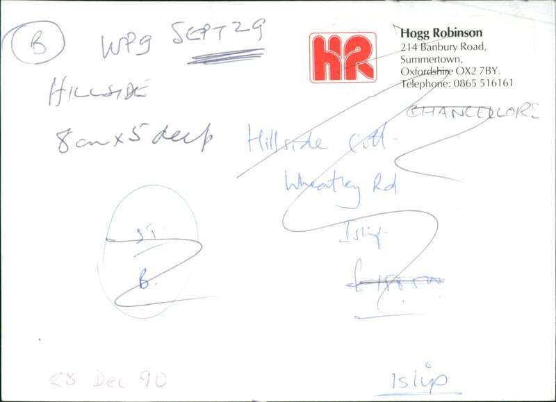 A man stands on a hillside, holding a spade and looking out at the landscape in front of him. - Vintage Photograph