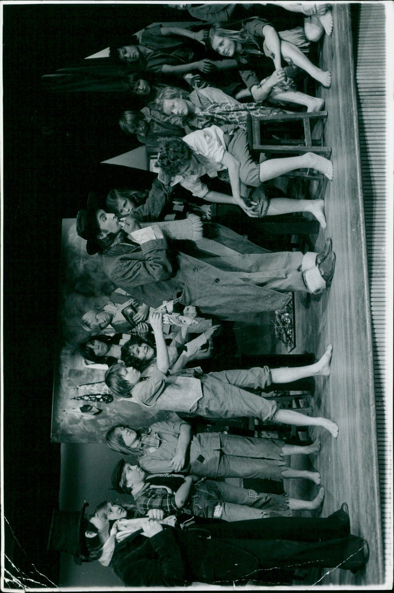 A group of people laughing and acting out a scene in a city street. - Vintage Photograph