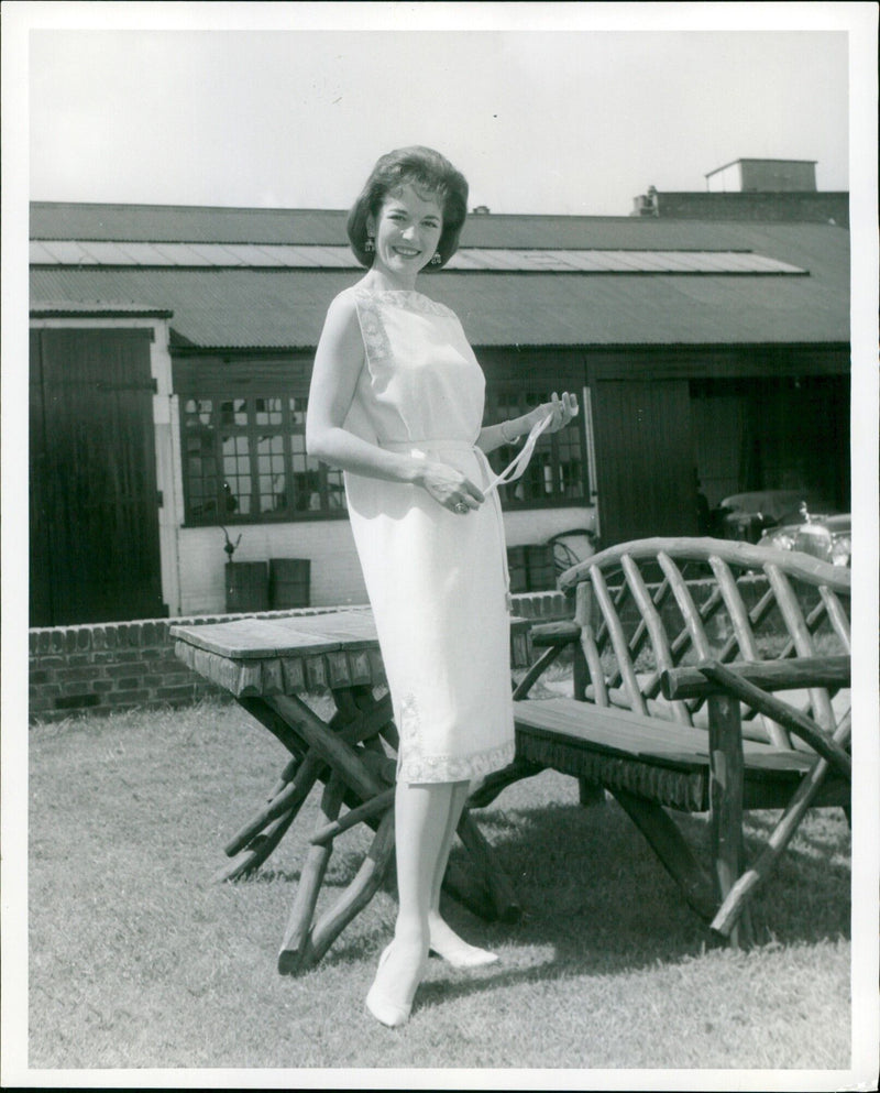 Actress Barbara Shelley models a light-cream wool Toga dress with gold Yemenite embroidery. - Vintage Photograph