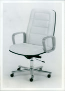 A Wood Programme Chair Model No. 551WSS Tract Limited design in an office setting. - Vintage Photograph