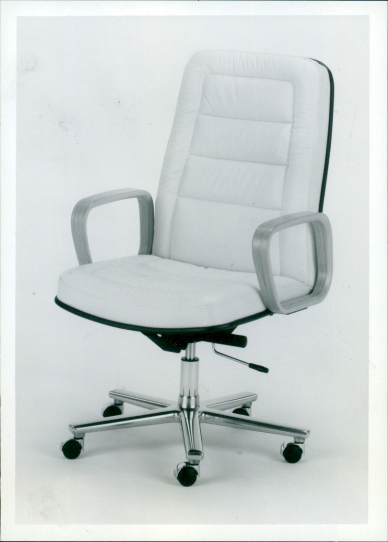 A Wood Programme Chair Model No. 551WSS Tract Limited design in an office setting. - Vintage Photograph
