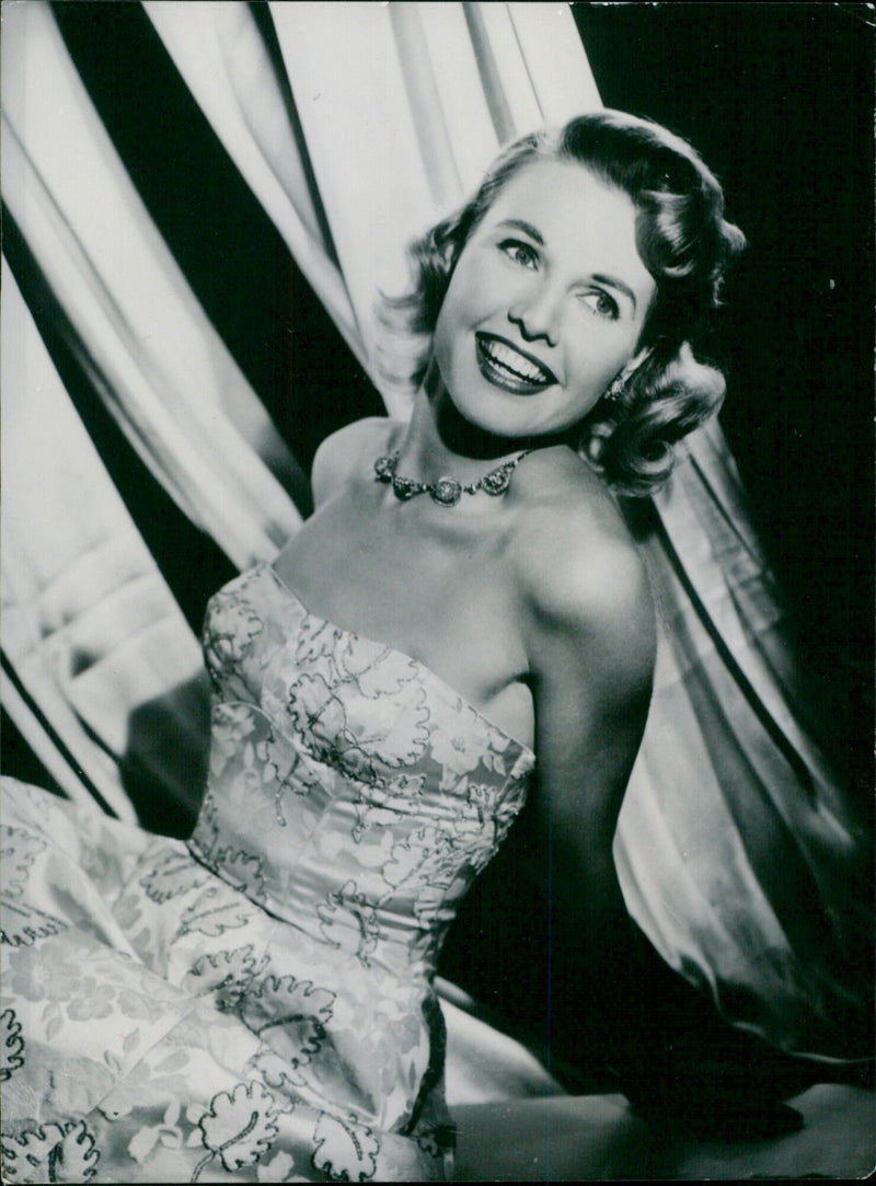 Actress Sheila Sim models a white brocade evening dress with a gold leaf motif. - Vintage Photograph