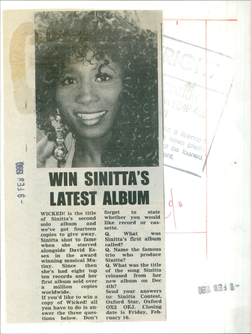 Singer Sinitta poses in front of her new album, Wicked!, which was released on February 9, 1990. - Vintage Photograph