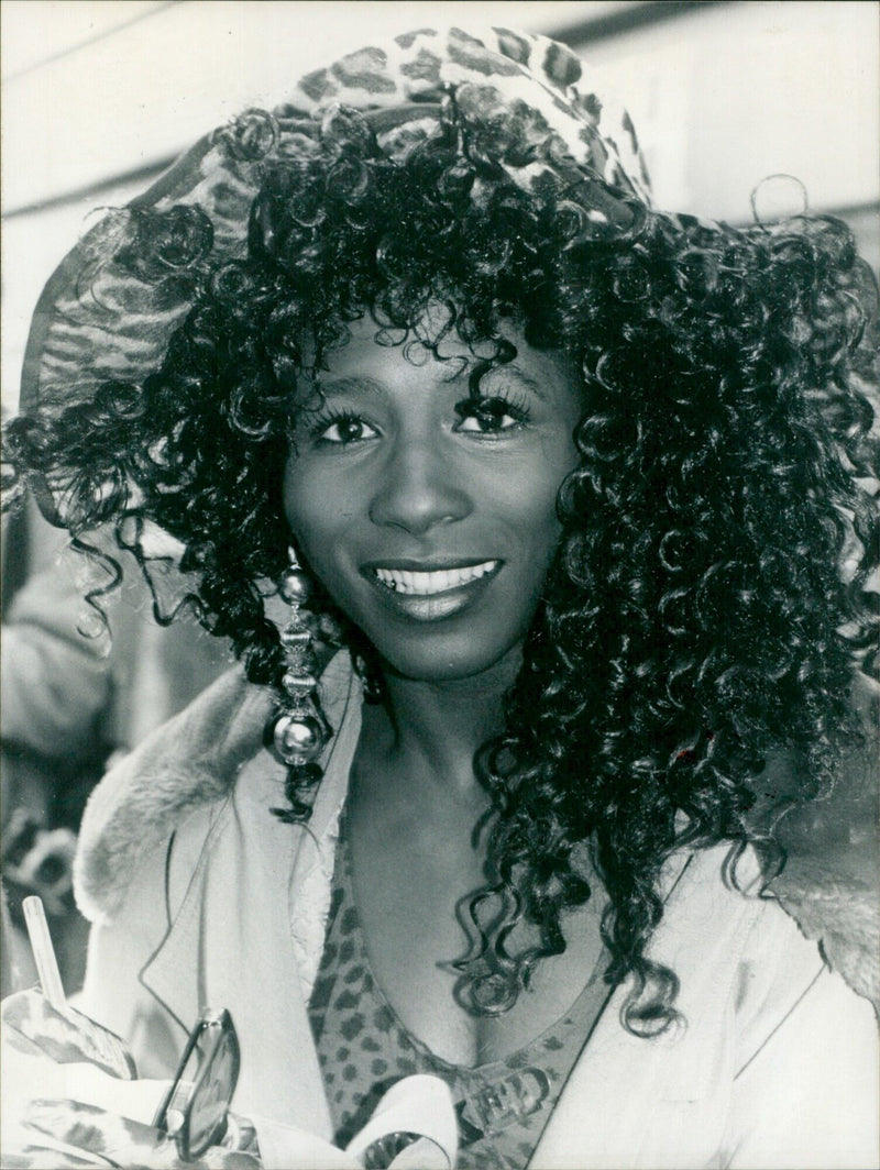 Singer Sinitta poses in front of her new album, Wicked!, which was released on February 9, 1990. - Vintage Photograph