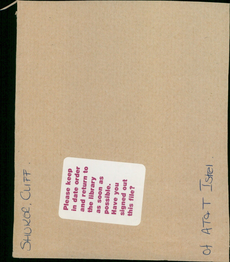 A hiker stands atop a cliff overlooking a valley. - Vintage Photograph