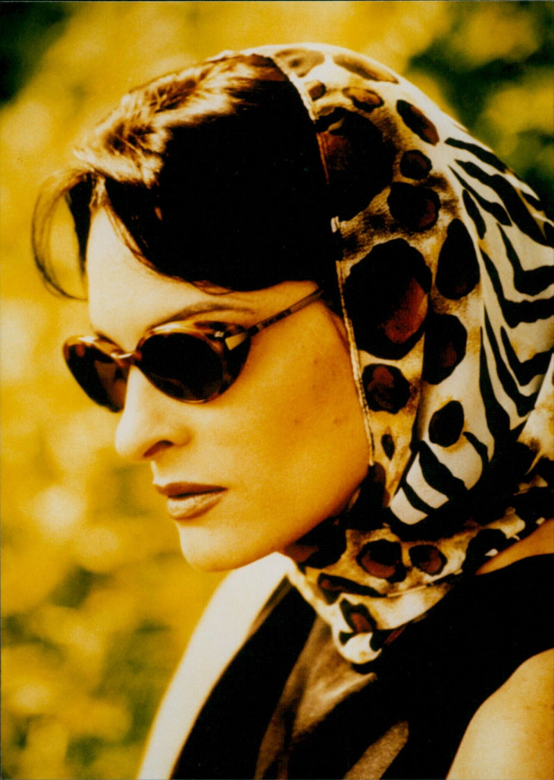 A model wearing a pair of Serengeti Eyewear glasses. - Vintage Photograph