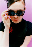A model wearing ‘Kangol Fat Nerd-Black’ eyewear. - Vintage Photograph