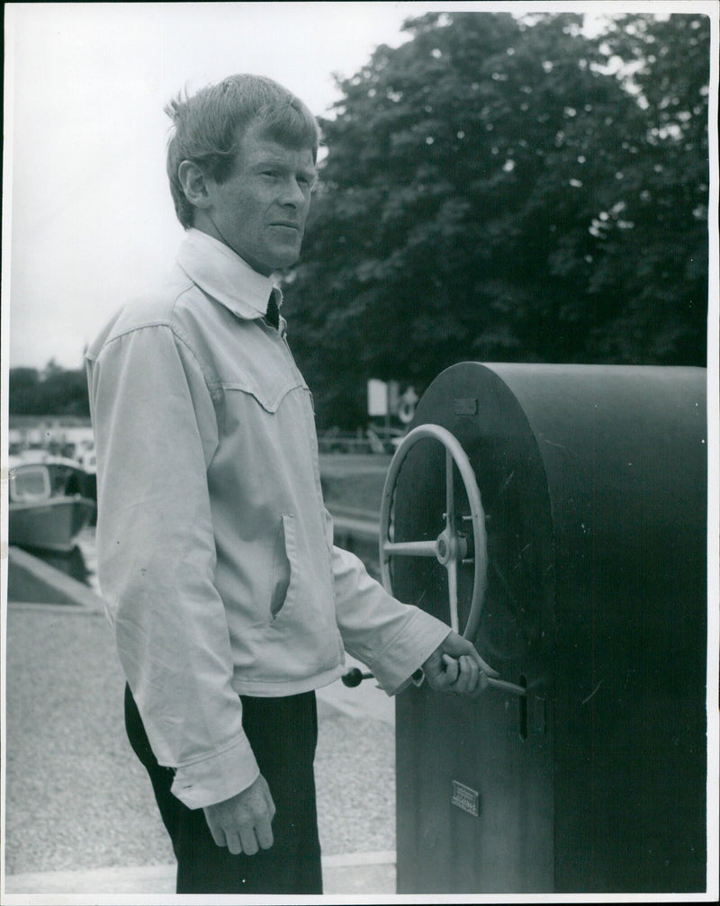Kenn Goning Lock Watt, the acting lock keeper, stands in front of the lock. - Vintage Photograph