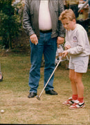 A beaver is seen swimming in a lake in the countryside. - Vintage Photograph