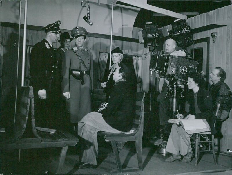 Actors Erik Hell, Lekan Igriny Hestergren, and Karl Forf-an Marika Stiernstedt are seen in a scene from the Swedish film, "Den Osynliga Muren" directed by Gustaf Molander. - Vintage Photograph