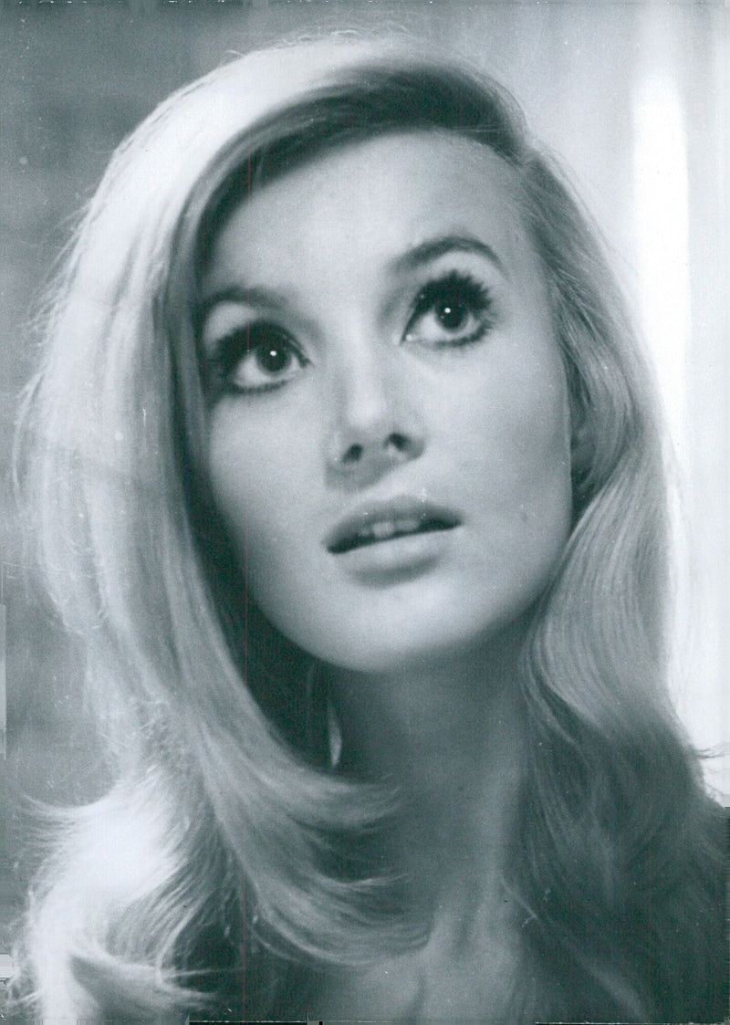 German actress Barbara Bouchet smiles in January 1966 for a photograph taken by Curt Gunther in Stockholm, Sweden. - Vintage Photograph