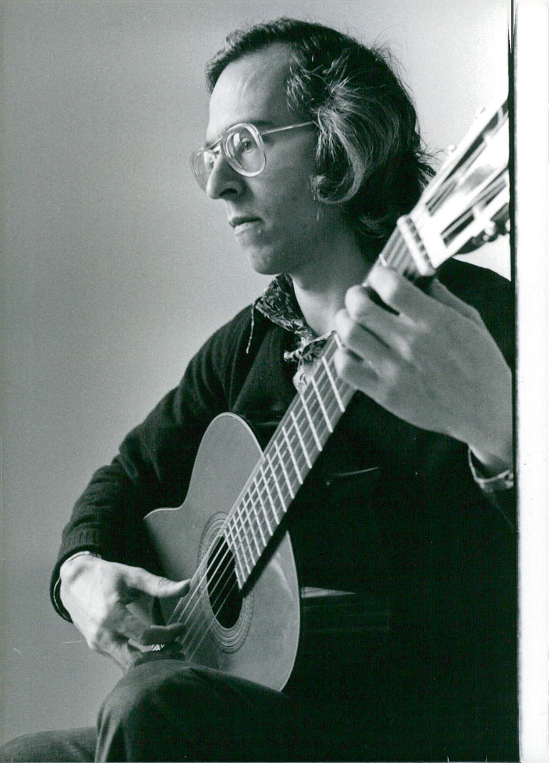 Australian classical guitarist John Williams performs in London, England in August 1980. - Vintage Photograph