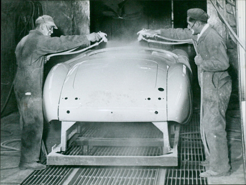 Workers at the MG factory in Abingdon body-spraying a car. - Vintage Photograph