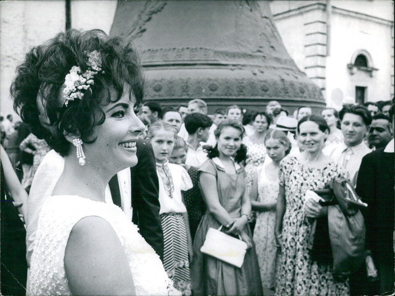 On October 13th, 1964, two people stand outside the Richelieu and Rus Richelieu buildings in Paris, France. The photograph was taken by photographer DALMAS and is copyrighted by them. - Vintage Photograph