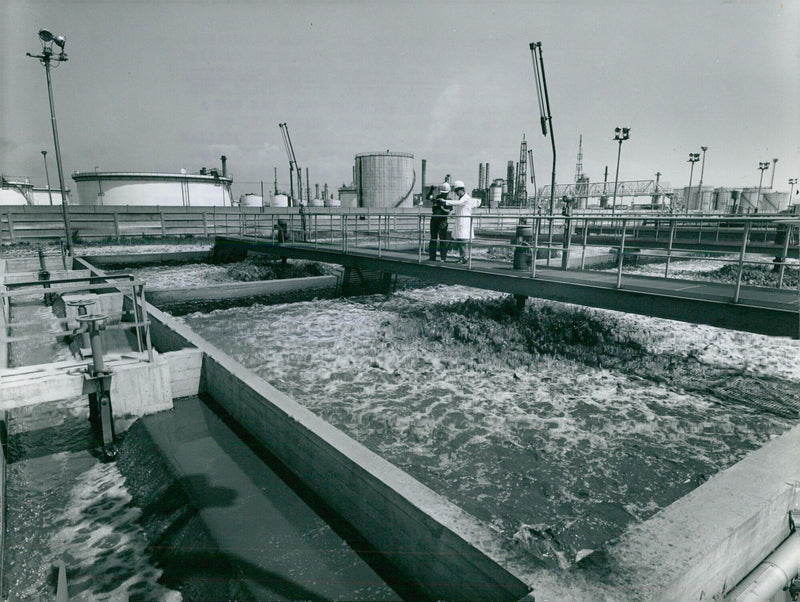 An Italian oil refinery is installing a 100% sure water depurator near Pavia, Italy, in order to protect the environment and combat pollution. - Vintage Photograph