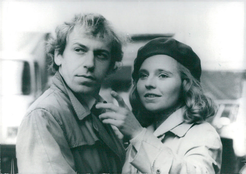 West German actors Rudiger Vogler and Hanna Schygulla pose for the camera at the premiere of their latest film, "Falsche Bewegung," which was awarded the lion's share of the 1975 Federal Film Prizes. - Vintage Photograph