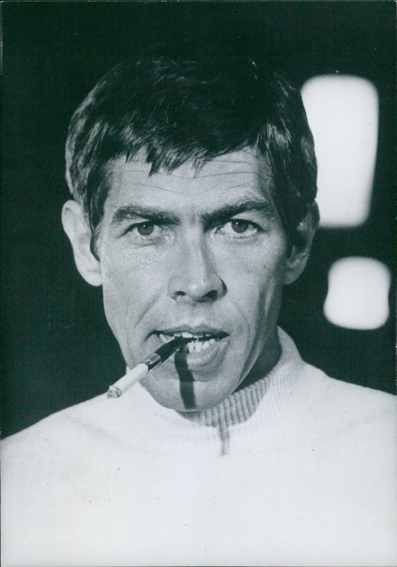 U.S. film stars James Coburn and co-star of the film "Our Man Flint" and its sequel "In Like Flint" pose for a photo in London. Coburn began acting in television commercials in the 1950s and has since been featured in several films. - Vintage Photograph