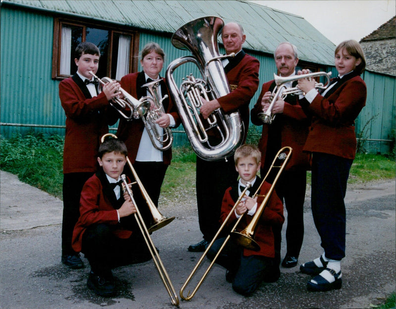 Members of the Roke Roke and Benson Brass Band stand in front of their hall in disrepair. - Vintage Photograph