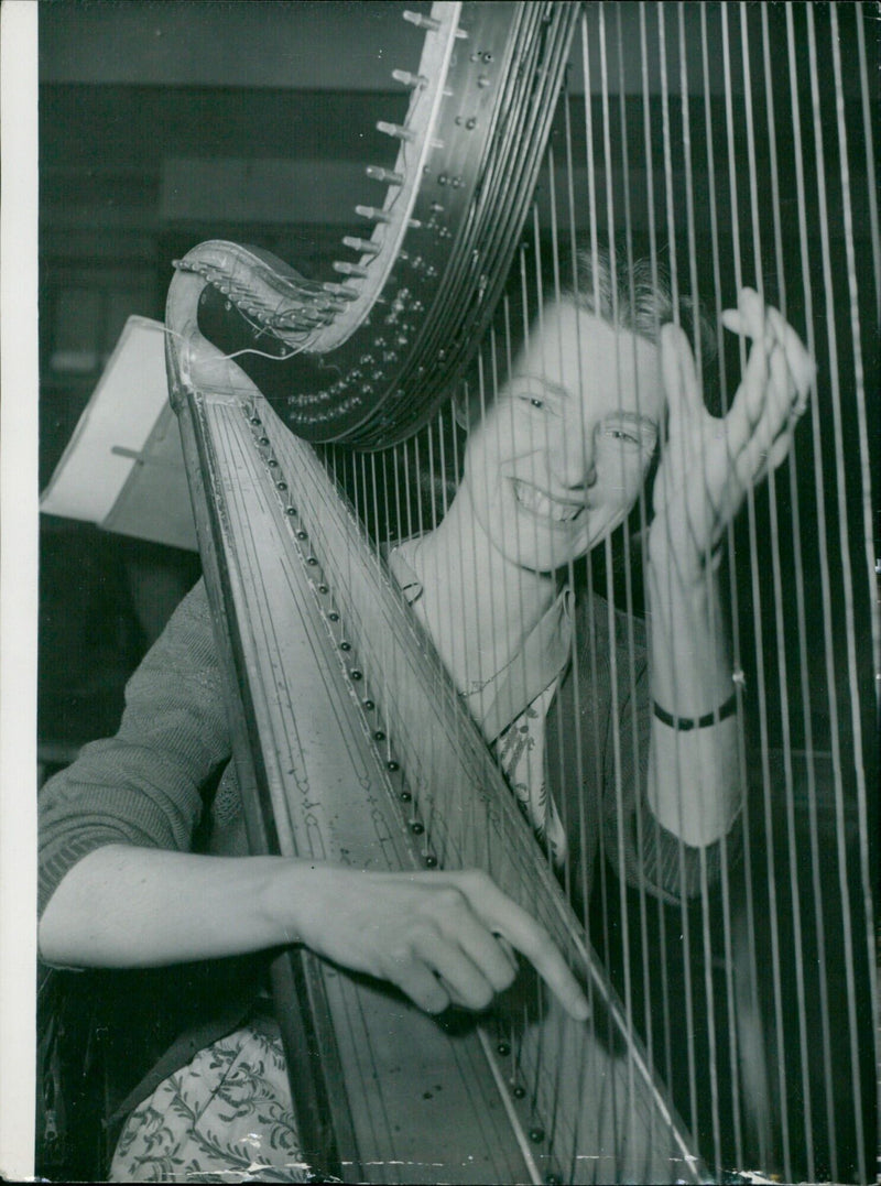 Gillian Smith plays the harp during a summer vacation course for musicians at Archbishop Tenison's Grammar School in London. - Vintage Photograph