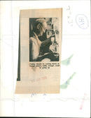 Musicians unloading violins from a truck outside a music venue. - Vintage Photograph