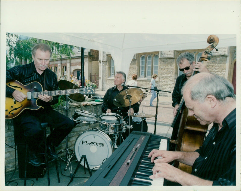 Bicester Jazz Festival attendees enjoy the music in the streets of Bicester Village and Sheep Street. - Vintage Photograph