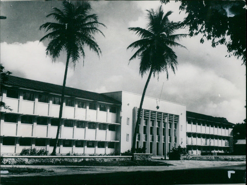 Members of the Federal House of Representatives stand in front of the newly built modern building which the Queen and Duke of Edinburgh will visit during their tour of Nigeria. - Vintage Photograph